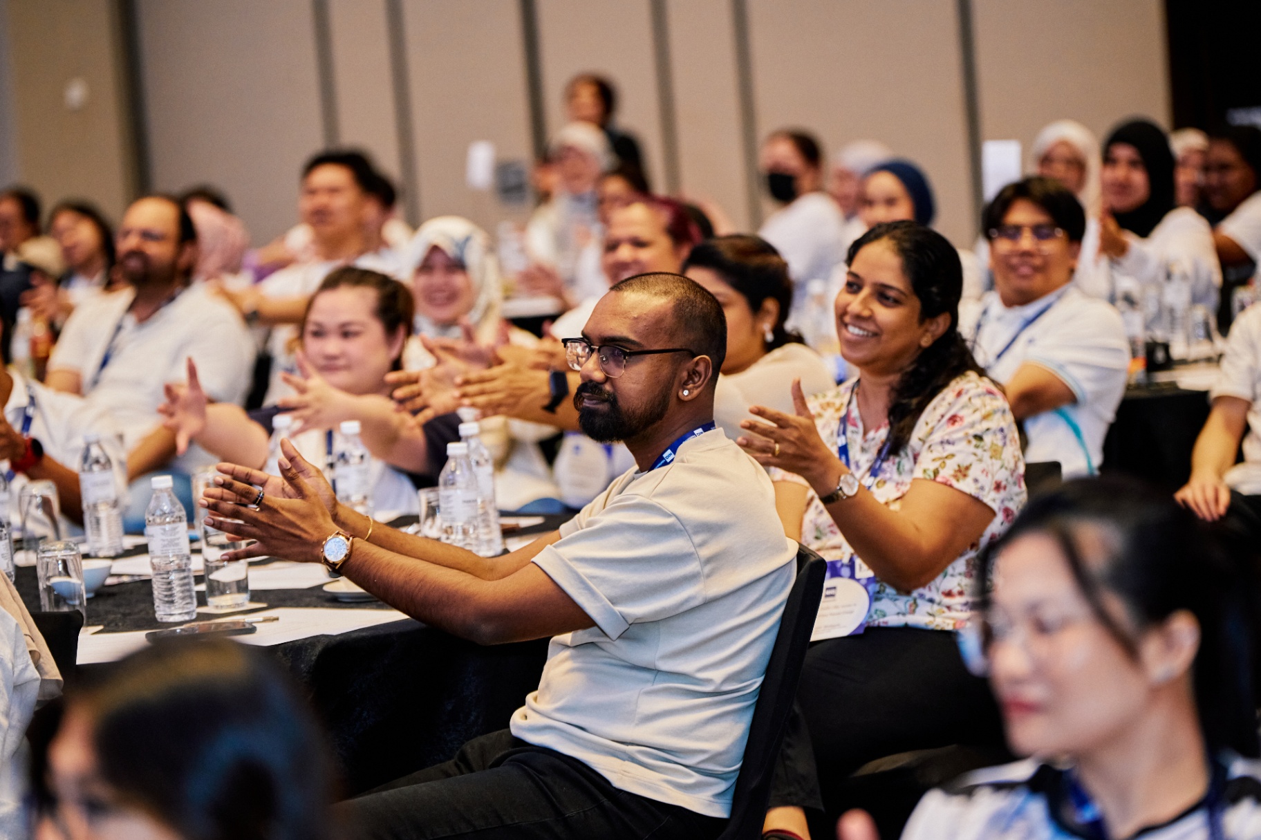 Engaged audience applauding at training