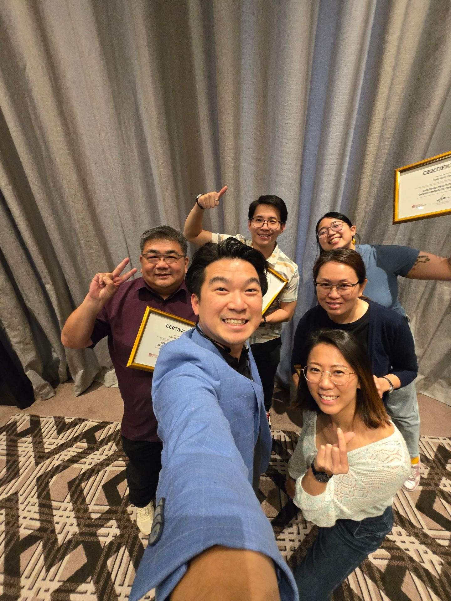 Certification graduates celebrating with trainer