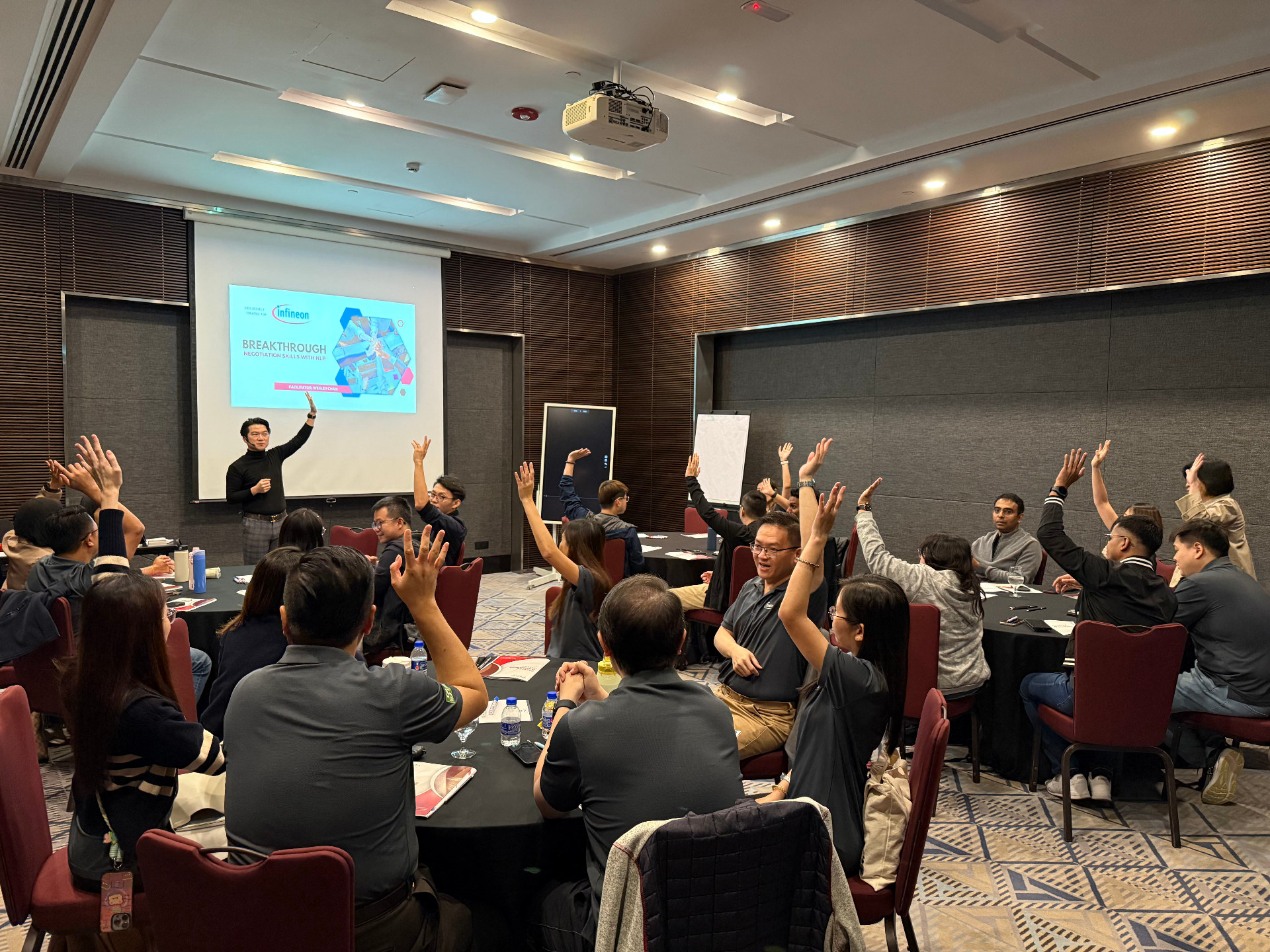 Development series workshop with participants raising hands