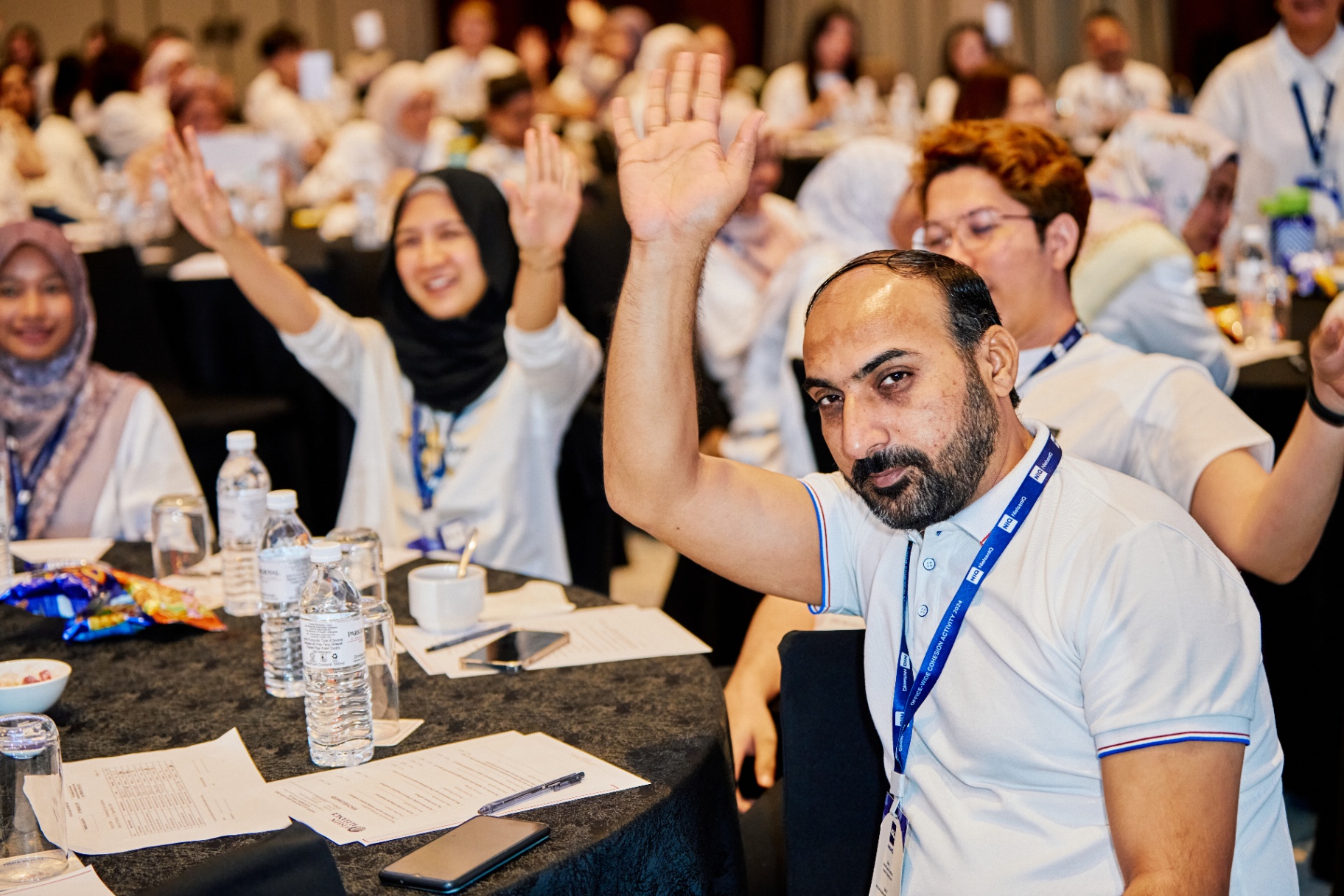 Participants raising hands during session